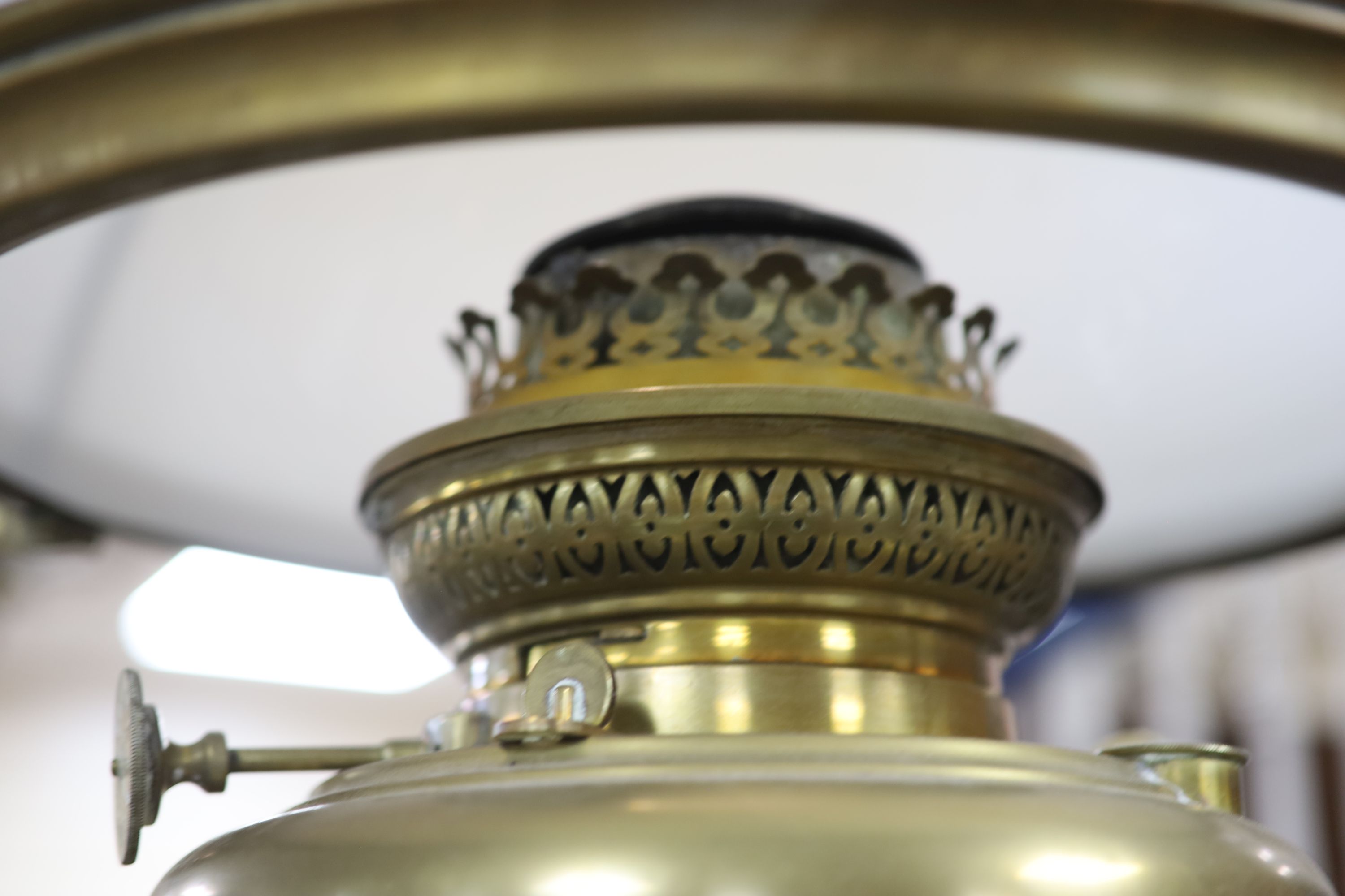 A Victorian brass hanging oil lamp, with a white opaque glass shade, drop 90cm